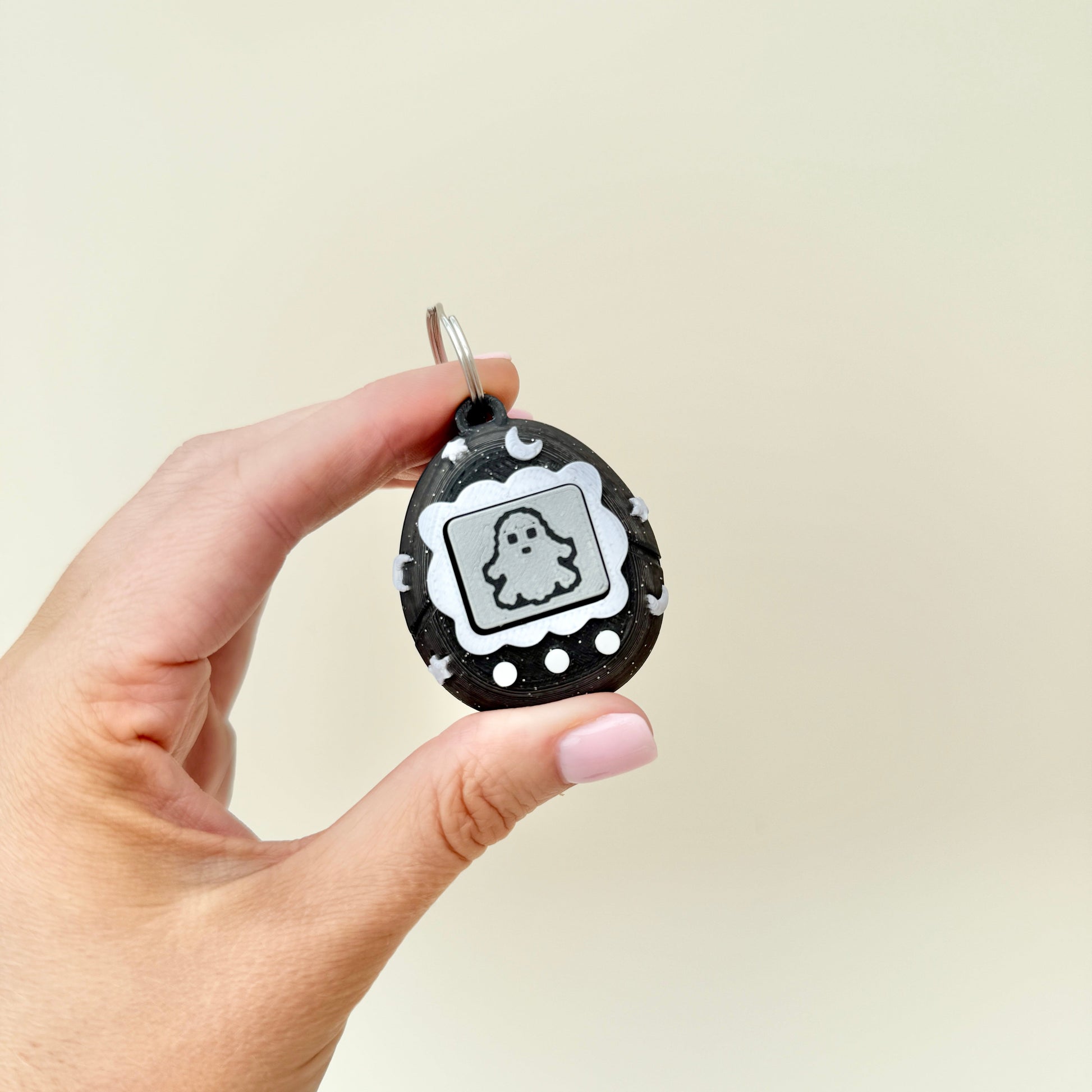 retro pixel-pet keychain clicker with textured screen and buttons

