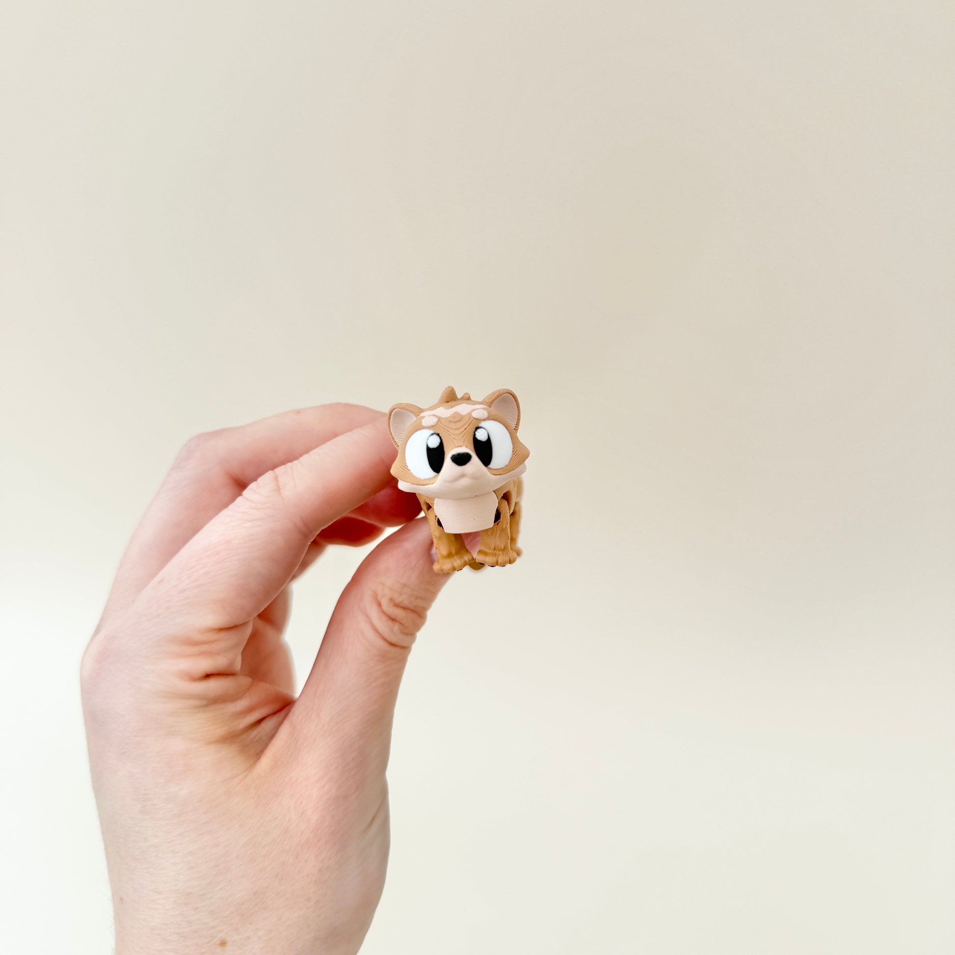 A cute, articulated ferret fidget toy designed for portability and interactive play.