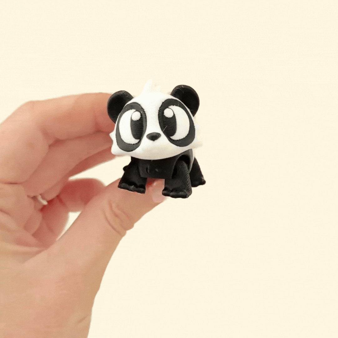 A small, fully flexible panda fidget toy with moveable parts and cute pink paw pads for sensory play.