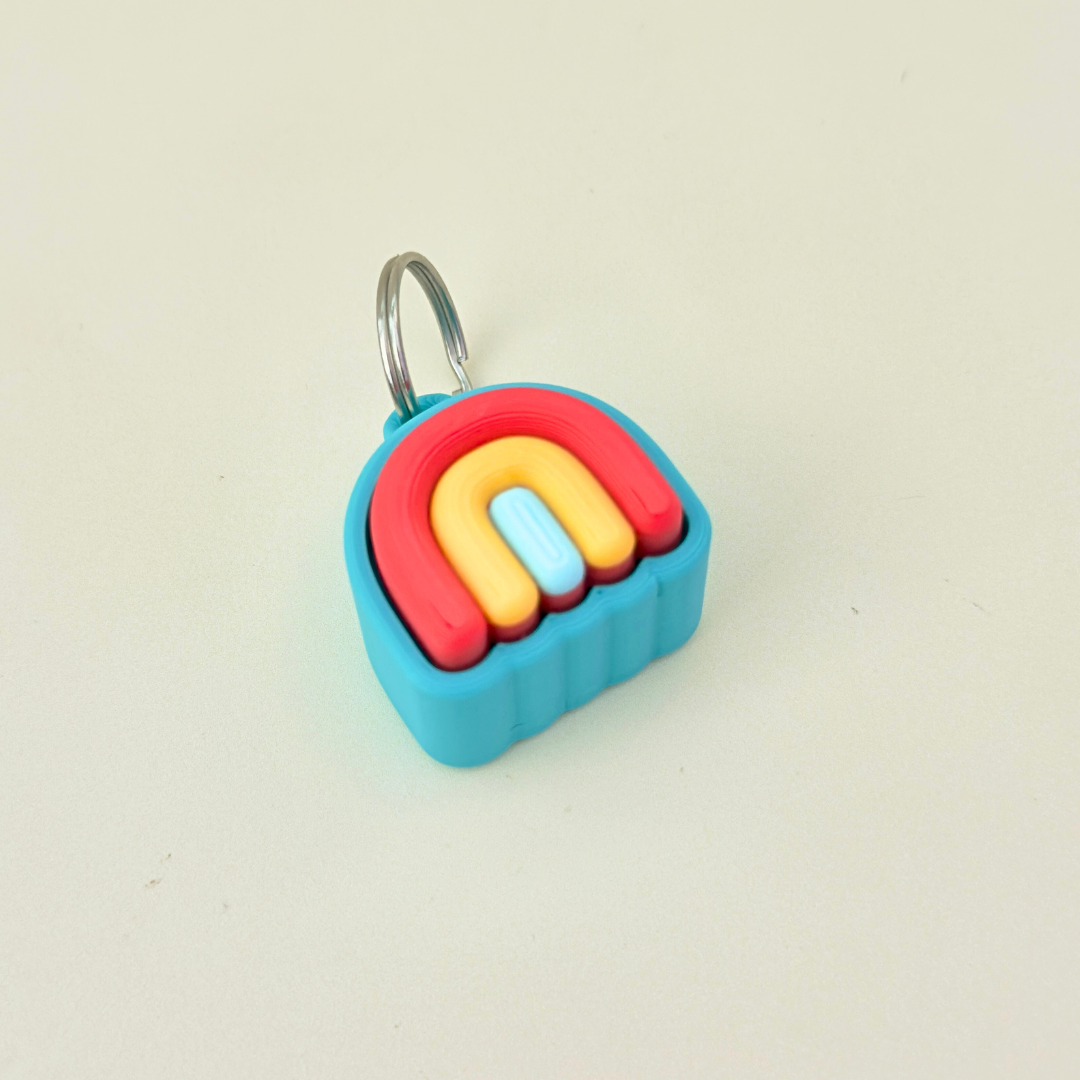 Compact keyring fidget clicker with layered colours; click or quiet options.
