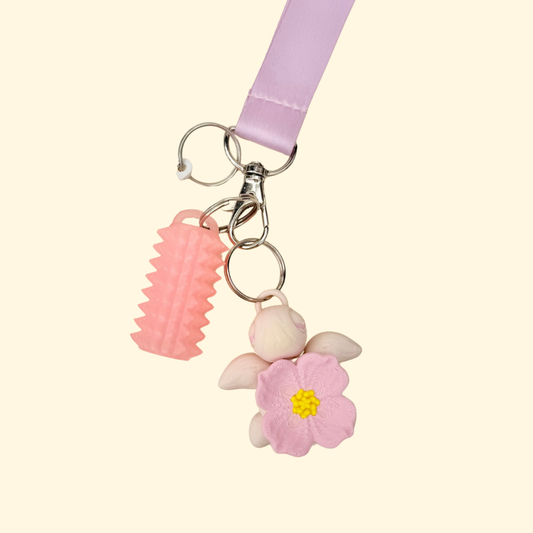 Compact fidget charm made to clip onto lanyards for discreet, everyday sensory stimming.
