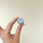 portable clicker fidget with raised anchor detail for sensory regulation
