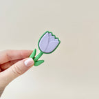 Compact tulip-shaped fidget toy in lilac and green, designed for portable sensory relief.