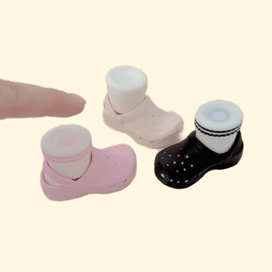 Small press-style clicker inspired by comfy clogs, tactile button feel, easy one-handed use, travel friendly.
