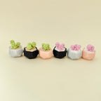 Small tactile stim toy shaped like a potted plant with keyring loop for everyday carry.