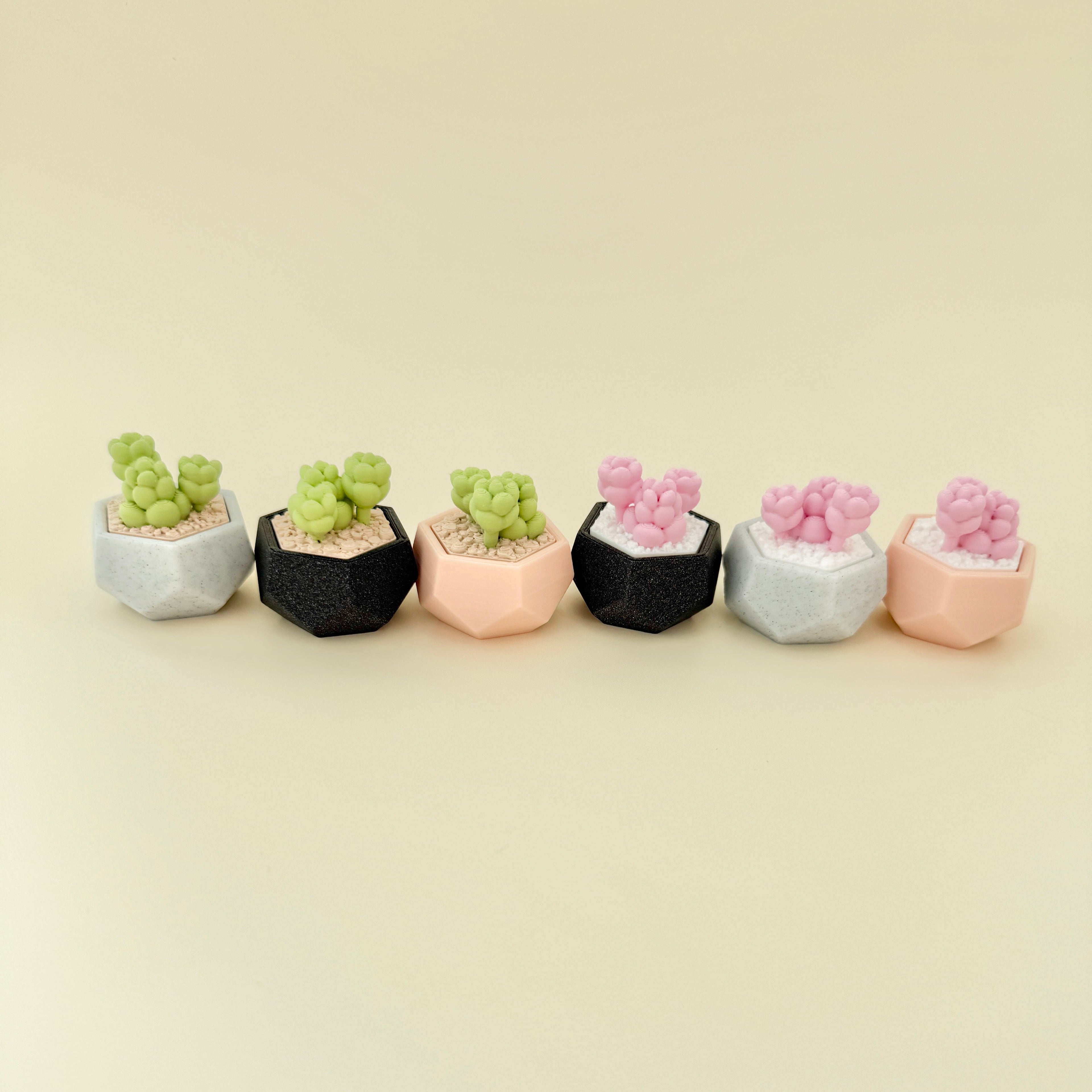 Small tactile stim toy shaped like a potted plant with keyring loop for everyday carry.