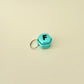 A pocket-sized clicker keyring designed for on-the-go fidgeting and personalised gifting.