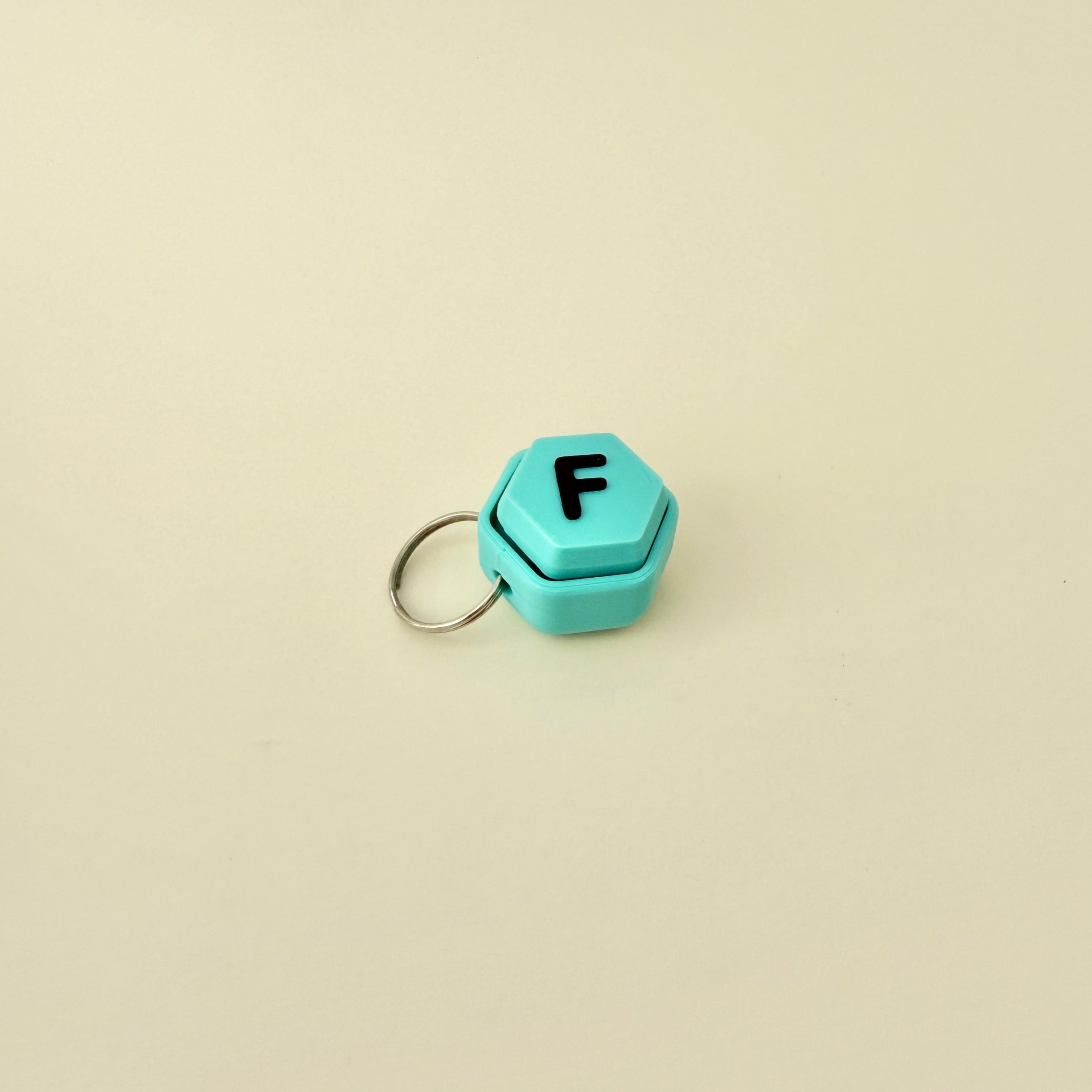 A pocket-sized clicker keyring designed for on-the-go fidgeting and personalised gifting.