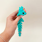 Lightweight hand-held dragon fidget; textured grip and quiet motion to support focus and regulation.
