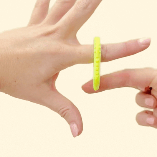 Flat fidget design with ridged textures and smooth grip points.