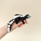 A realistic skunk toy with a poseable tail and movable parts, great for fidgeting, sensory play, and display.