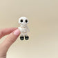 Pocket-size skeleton figure with moving arms, legs, head and body for gentle fidgeting.
