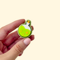 Lime green fidget clicker shaped like a potion with gold star textures for sensory play