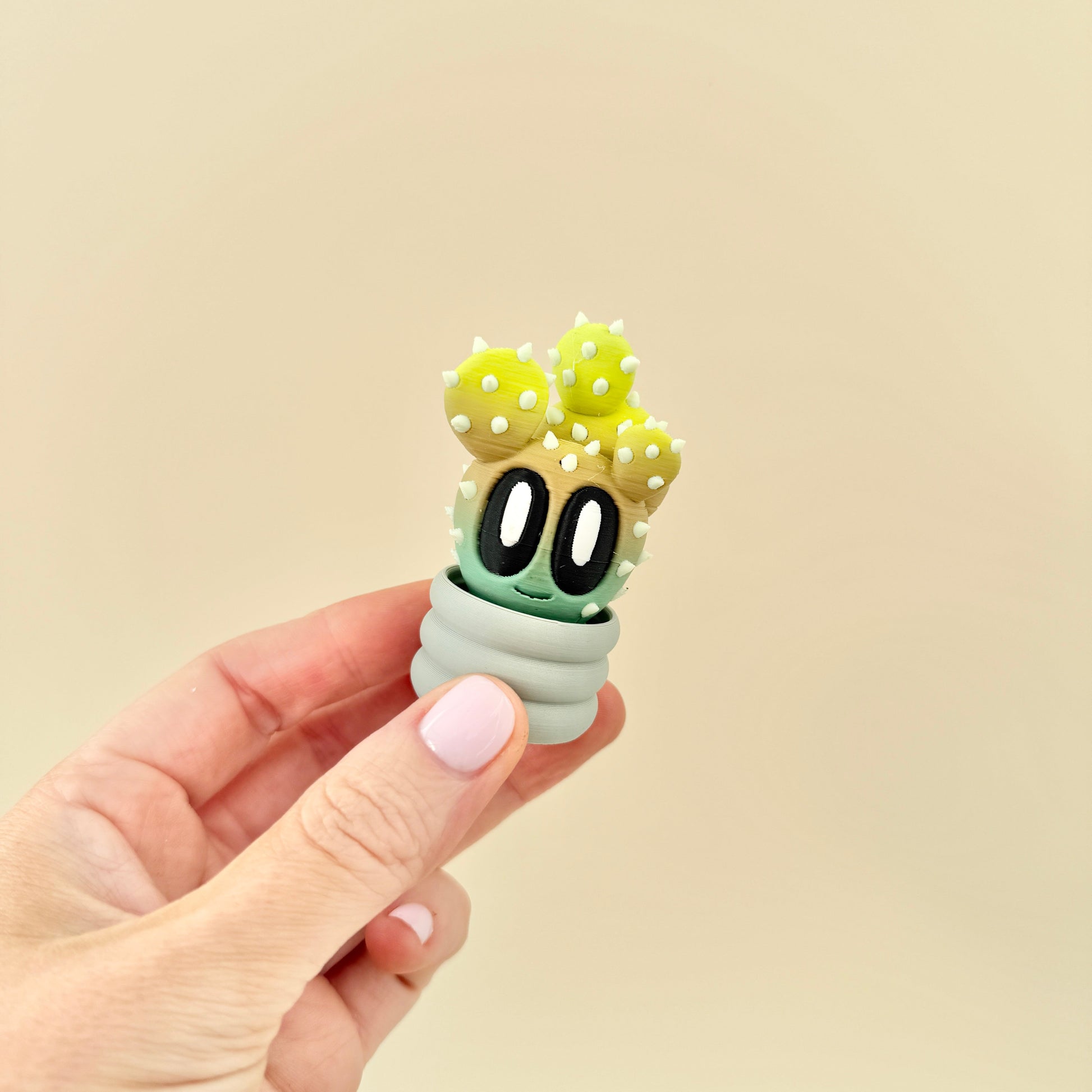 Mini cactus-style toy with raised white spots and yellow details, perfect for pain stimming and desk display.