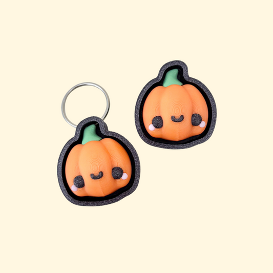 pumpkin-shaped clicker fidget with keyring loop and textured details for sensory regulation
