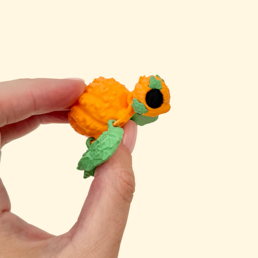 Articulated turtle fidget with pumpkin-style shell and raised textures for sensory tracing and calming play.
