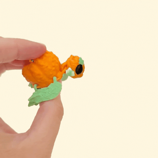 Small pumpkin turtle fidget with movable body and tactile shell for grounding, desk fidgeting, or gifting.