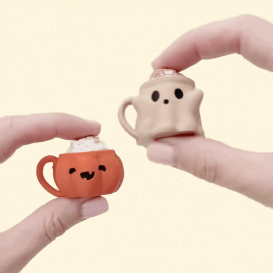 Orange pumpkin-face mug with whipped cream top and press-to-click action.
