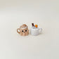 Orange pumpkin-face cup with creamy swirl topper, available as click or quiet click.
