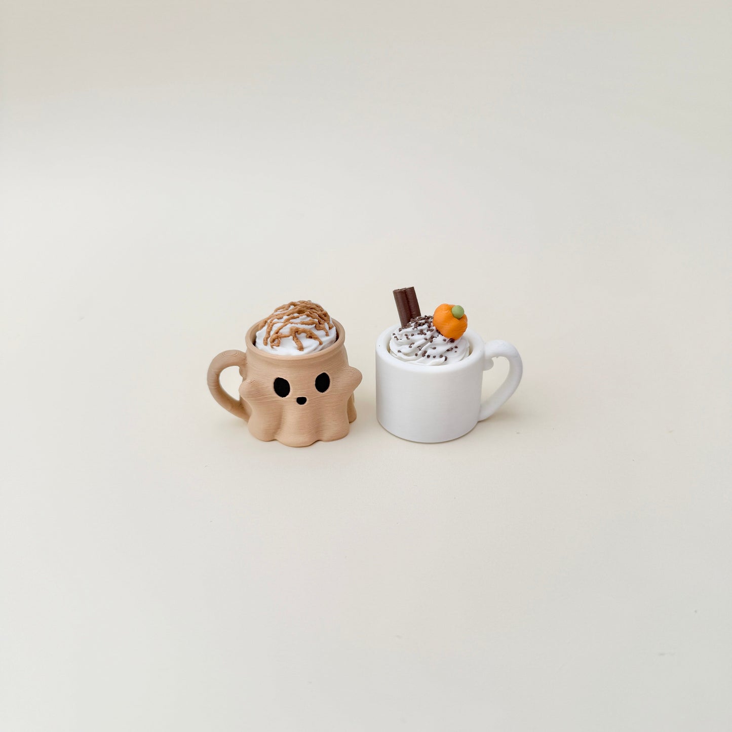 Orange pumpkin-face cup with creamy swirl topper, available as click or quiet click.
