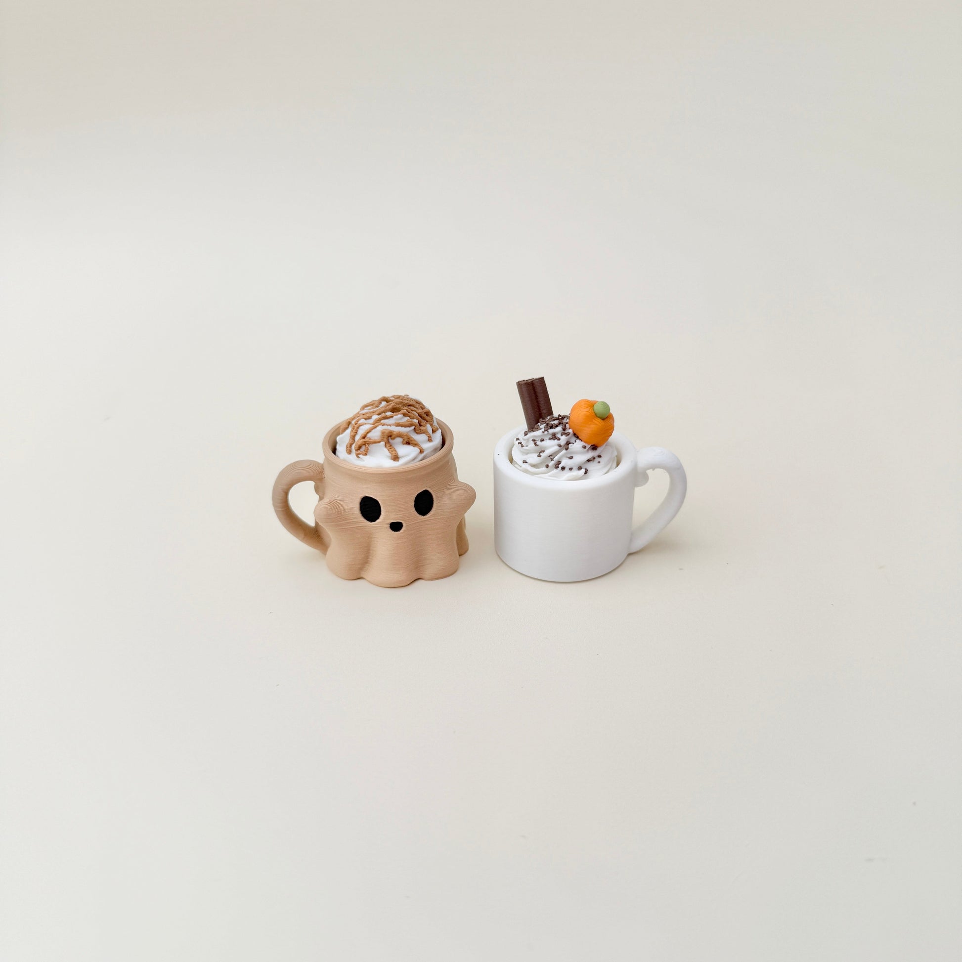 Orange pumpkin-face cup with creamy swirl topper, available as click or quiet click.
