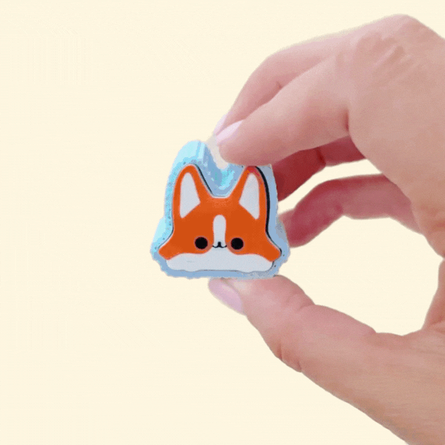 assorted dog-breed fidget clickers on a neutral background
