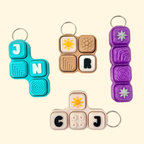 Colorful keychains with different designs on a beige background