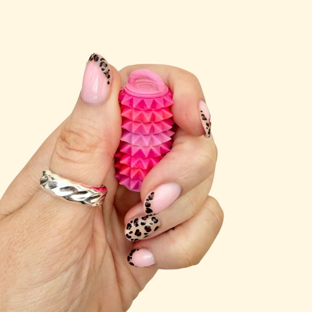 Non-click sensory fidget providing firm pressure feedback for focus and regulation.