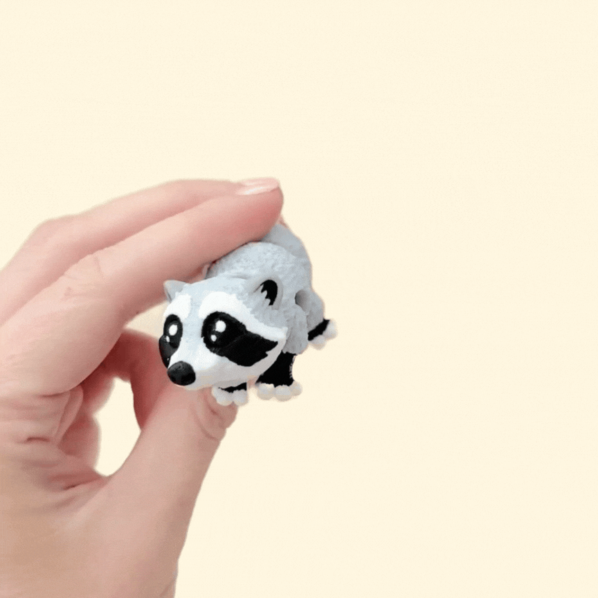 Realistic raccoon fidget toy with mottled grey, white, and black details, 10cm in length.