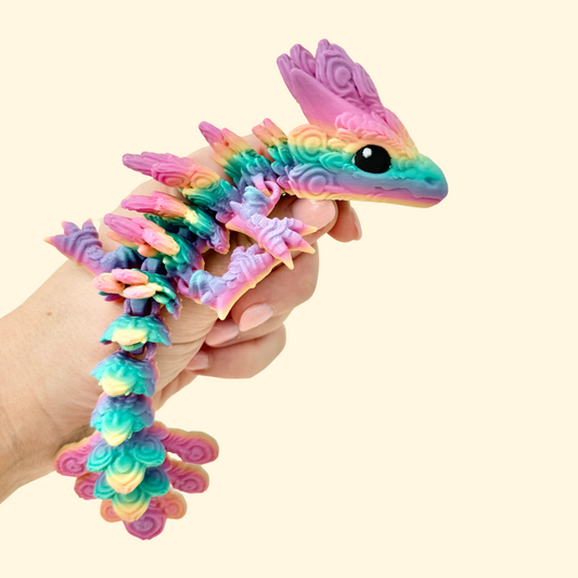 Colourful articulated dragon toy with raised feather textures and a full-body flexible design.