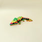 colourful articulated dragon toy with raised detailing for sensory input, suitable for focus breaks and desk play

