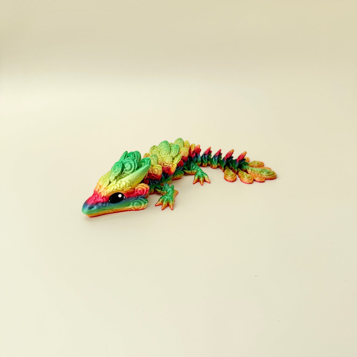 colourful articulated dragon toy with raised detailing for sensory input, suitable for focus breaks and desk play
