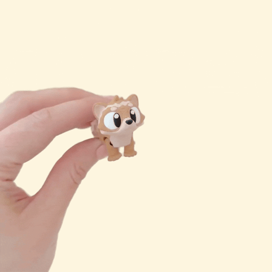 A small ferret-shaped fidget toy with a movable head, legs, and body for stress relief.