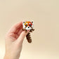 Lifelike red panda toy with a fully flexible design and a shimmering red and brown finish.