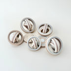 A compact and portable fidget spinner with a neutral colour gradient, perfect for discreet use.