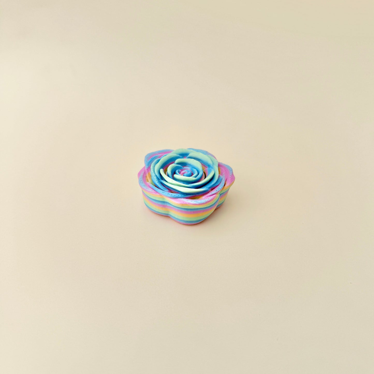 A 4cm rainbow rose fidget spinner designed for calming and focus.