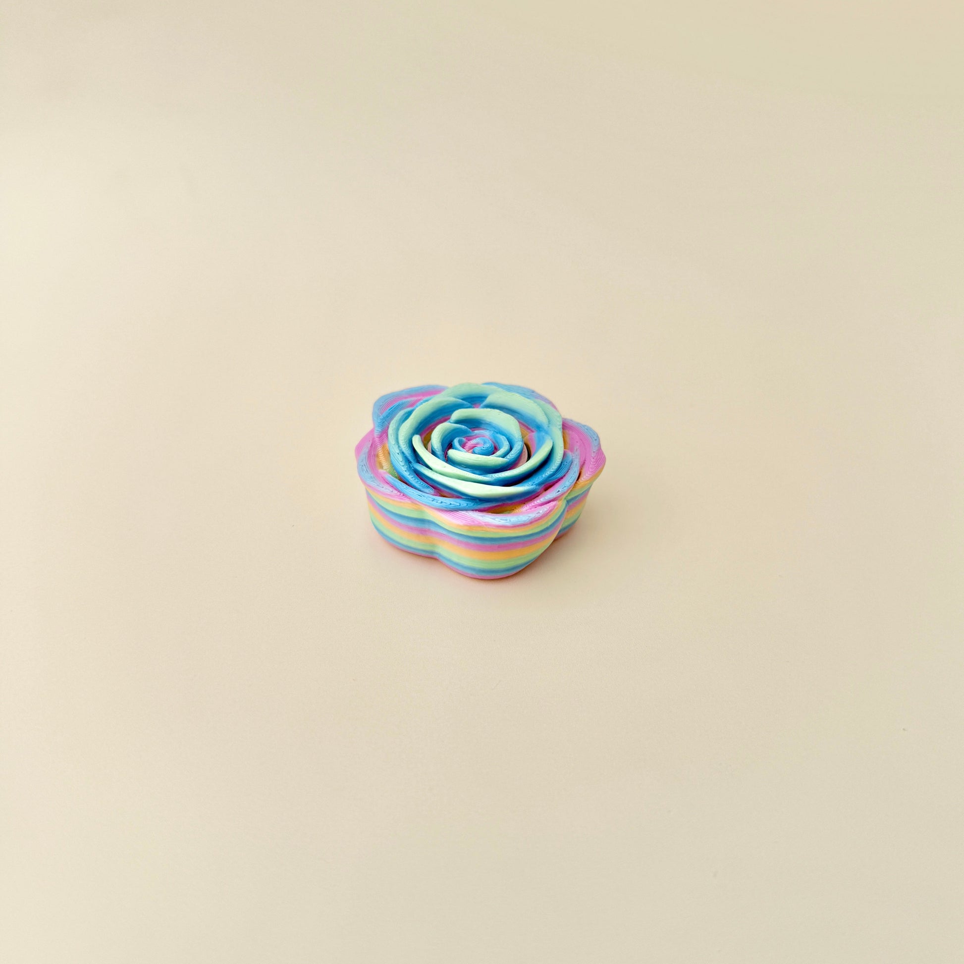 A 4cm rainbow rose fidget spinner designed for calming and focus.