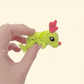 Small poseable dinosaur fidget with red nose and antlers; smooth movement, compact desk toy for adults and teens.
