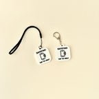 A compact and stylish SafeTag keyring designed for NFC functionality, available in sleek black or white.