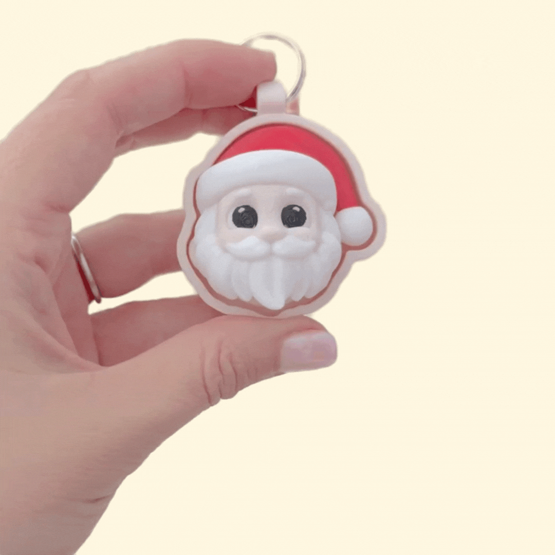 3D festive face clicker, 6 cm, raised details for tracing, keyring loop; available in click or quiet for sensory-friendly use.
