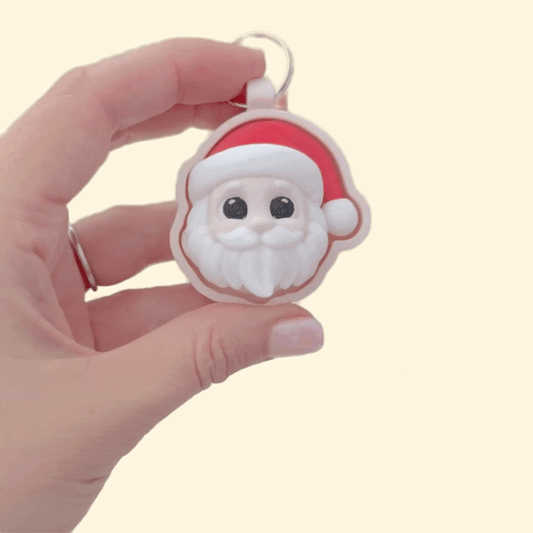3D festive face clicker, 6 cm, raised details for tracing, keyring loop; available in click or quiet for sensory-friendly use.
