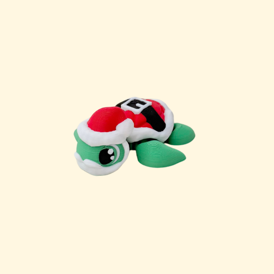 Small 5 cm festive turtle fidget in green and red for Christmas displays and quiet desk fidgeting.
