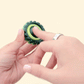 compact green spinner with raised outer teeth for tracing and focus
