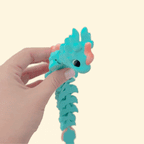 Tactile, articulated dragon with raised scales for tracing; flexible body for rhythmic, quiet fidgeting.
