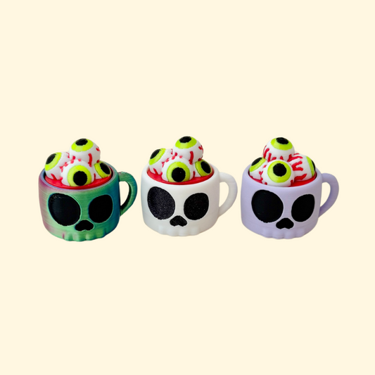skull-shaped cup clicker fidget with eyeball button for sensory play
