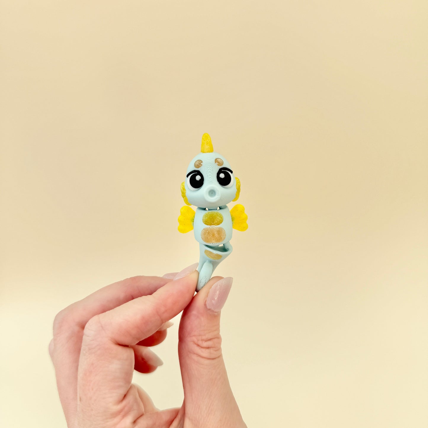 Shimmering yellow details highlight this articulated sea-themed fidget toy.