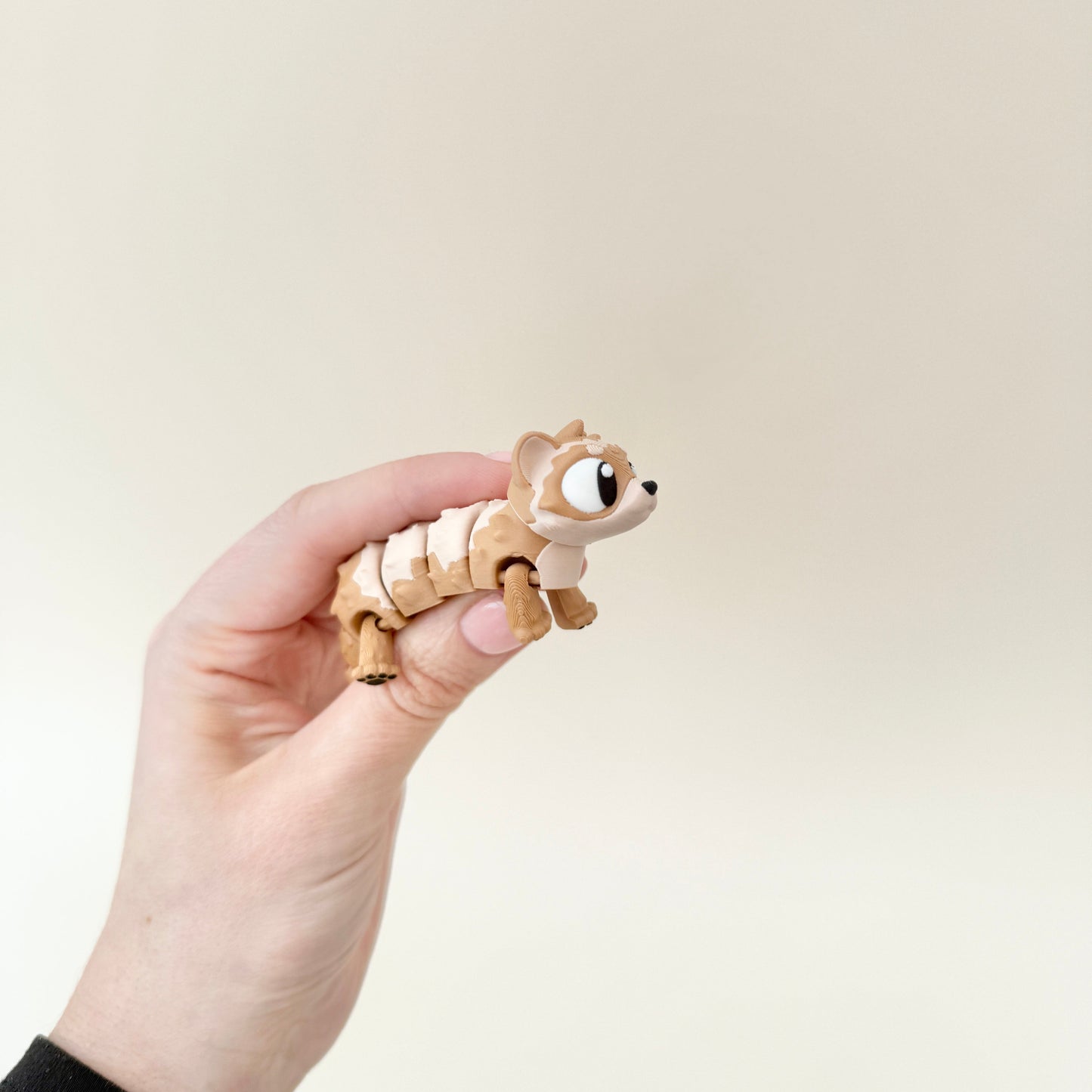 A ferret fidget toy designed for sensory stimulation, featuring a lifelike furry texture.