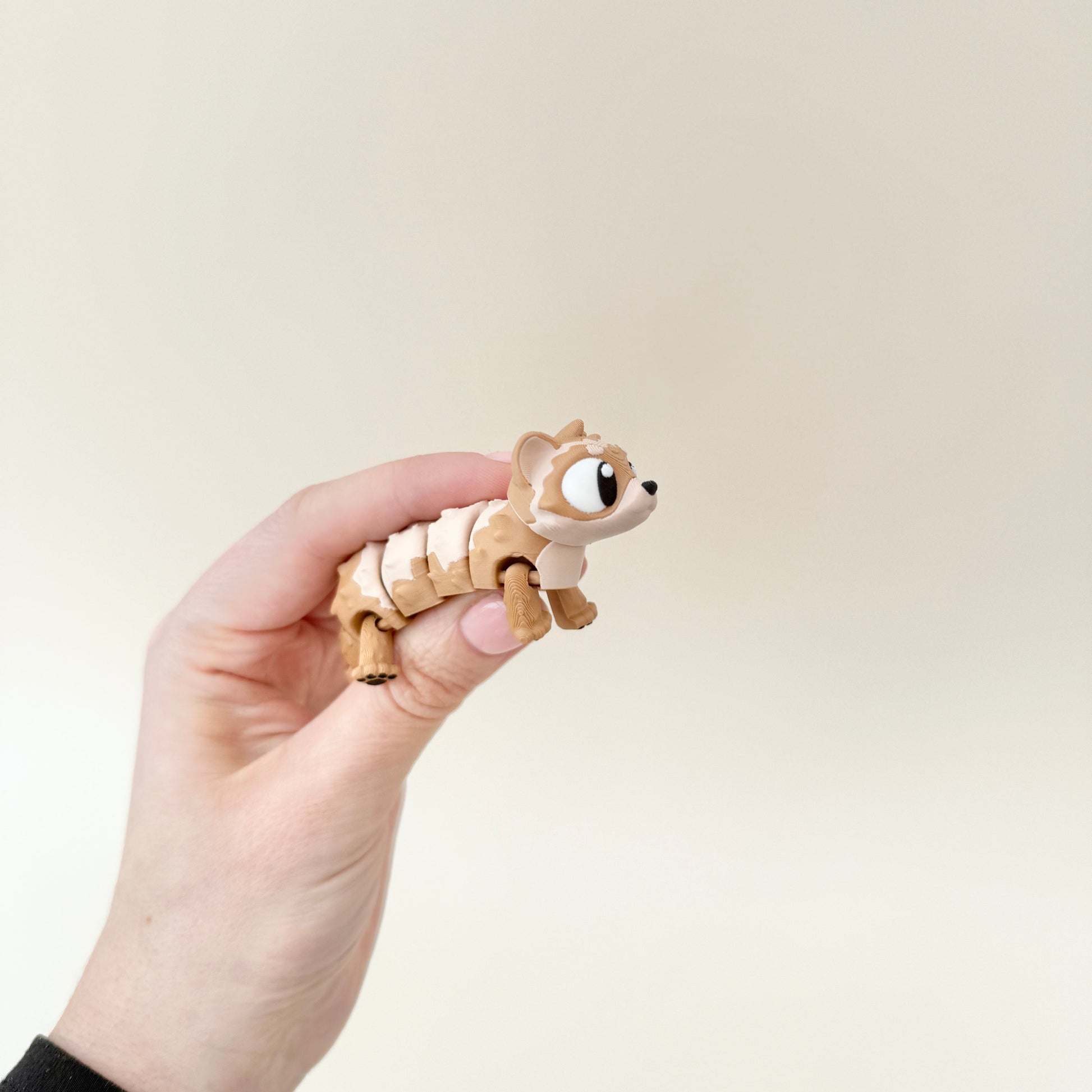 A ferret fidget toy designed for sensory stimulation, featuring a lifelike furry texture.
