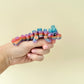 11cm fidget dragon featuring bold rainbow colours and tactile feedback, suitable for stress relief and focus.