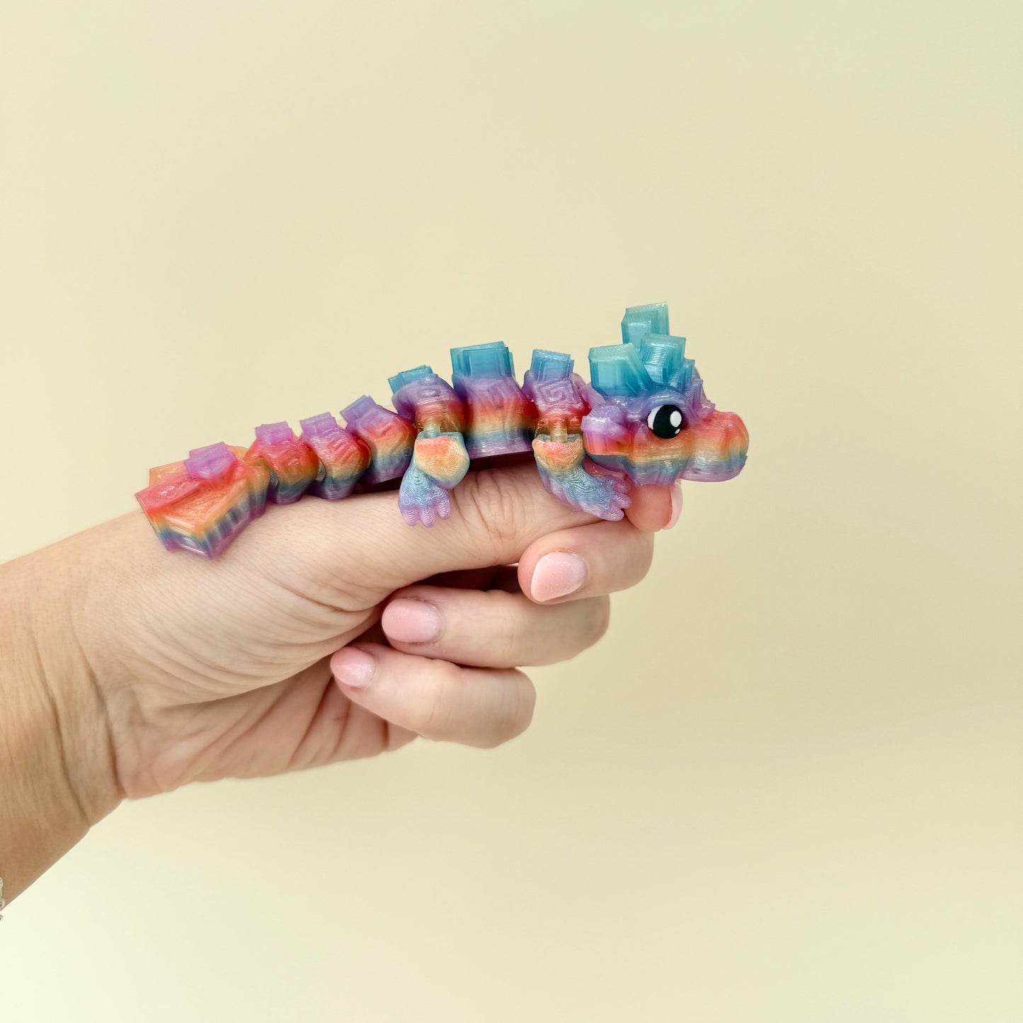 11cm fidget dragon featuring bold rainbow colours and tactile feedback, suitable for stress relief and focus.